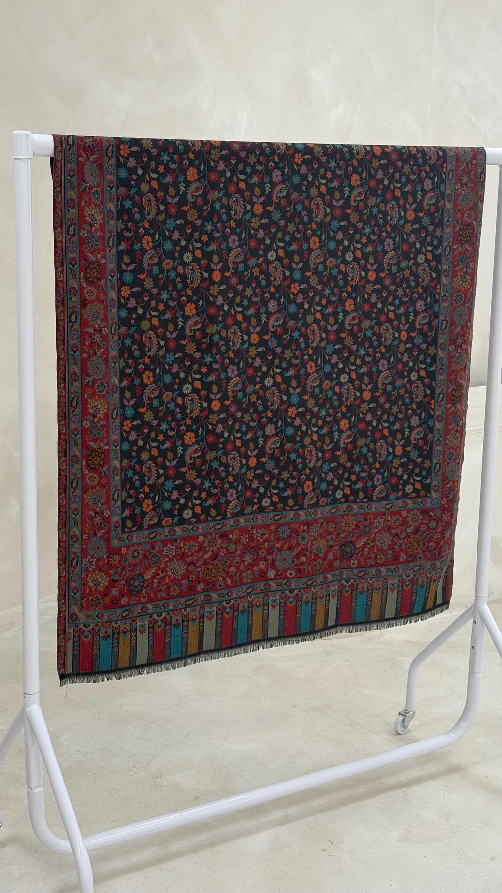 Decorative scarf with a floral pattern on a white stand